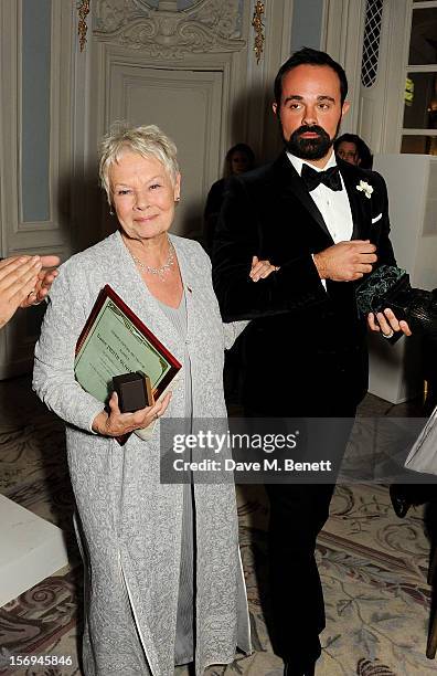 Evgeny Lebedev walks Dame Judi Dench to the stage to collect the Moscow Art Theatre's Golden Seagull award at the 58th London Evening Standard...