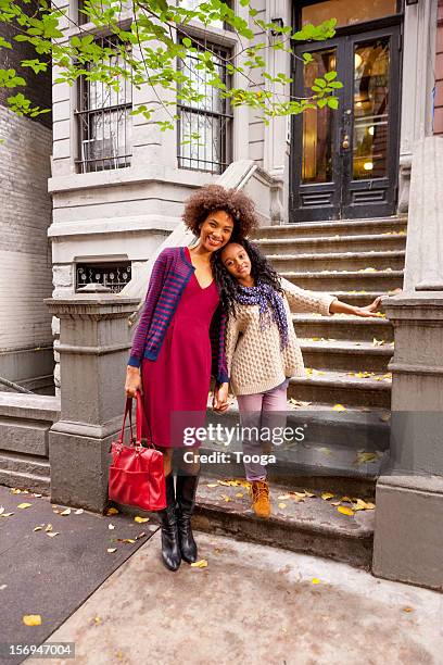 mother and daughter in front of their home - leanincollection working mom fotografías e imágenes de stock