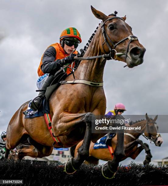 Galway , Ireland - 1 August 2023; Arctic Fly, with Sean O'Keeffe up, left, jump the fourth on their way to winning the Colm Quinn BMW Novice Hurdle...