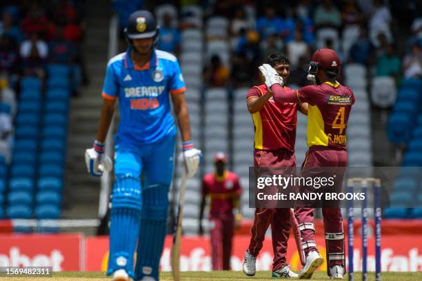 Gudakesh Motie and Shai Hope of West Indies celebrate the dismissal of Shubman Gill of India during the third One Day International cricket match...