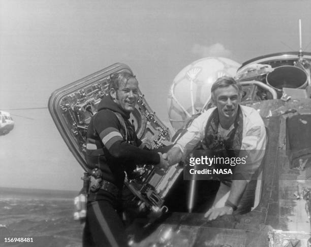 Astronaut Eugene Cernan, Commander of the Apollo 17 lunar mission, is welcomed back to Earth by a US Navy Pararescueman, after splashdown in the...