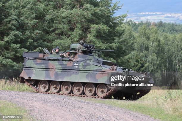 August 2023, Thuringia, Bad Salzungen: An armored personnel carrier of the type "Marder" drives over the training area of the Werratal Barracks....