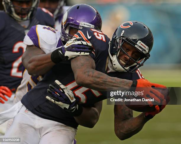 Brandon Marshall of the Chicago Bears is tackled by Jasper Brinkley of the Minnesota Vikings after a catch at Soldier Field on November 25, 2012 in...