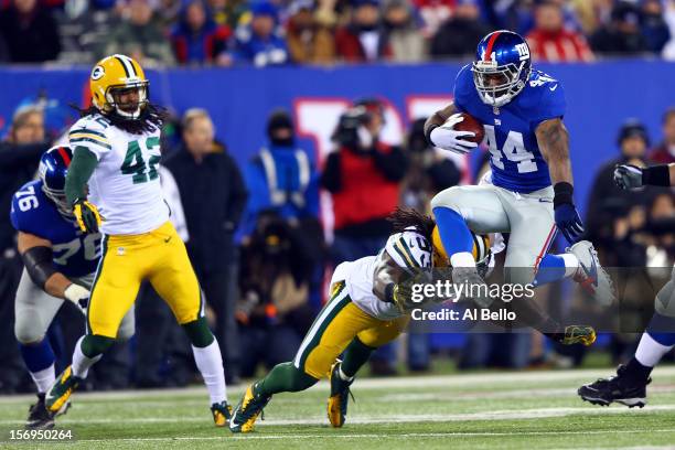 Running back Ahmad Bradshaw of the New York Giants jumps over the tackle of outside linebacker Erik Walden of the Green Bay Packers at the begining...