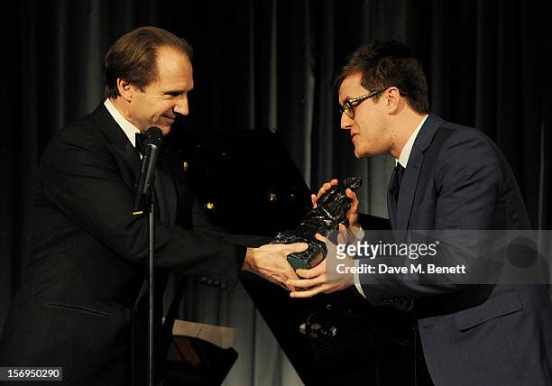 Nick Payne accepts the award for Best Play for 'Constellations' from Ralph Fiennes at the 58th London Evening Standard Theatre Awards in association...