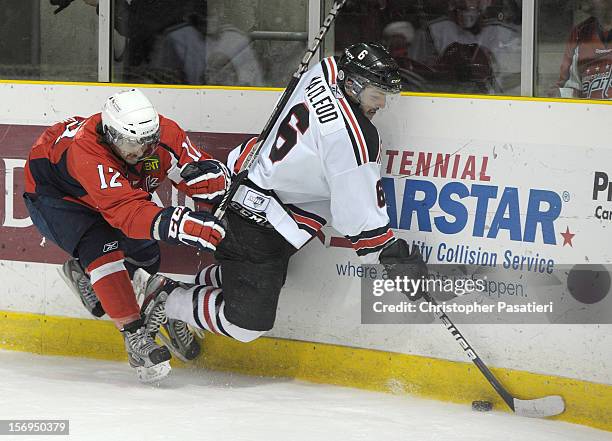 Jonathan Aubertin of the Summerside Western Capitals checks Daniel MacLeod of the Weeks Crushers during the third period on November 25, 2012 at the...