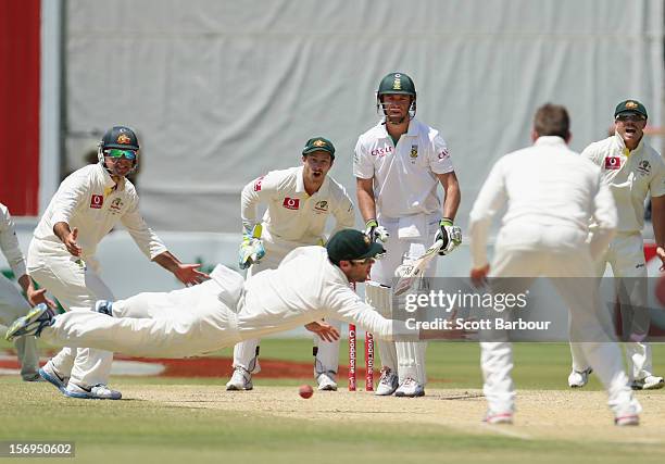 Rob Quiney of Australia dives as he attempts to take a catch as batsman AB de Villiers of South Africa looks on during day five of the Second Test...