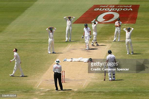 Rob Quiney of Australia lays on the pitch after attempting to catch out Faf du Plesis of South Africa off a delivery by captain Michael Clarke during...
