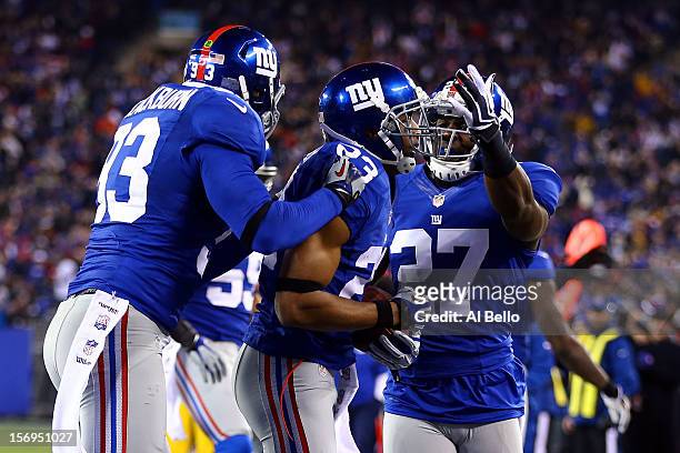 Cornerback Corey Webster of the New York Giants celebrates after an interception in the first quarter with teammates middle linebacker Chase...