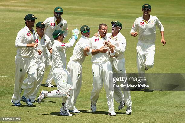 Peter Siddle of Australia celebrates with his team mates after taking the wicket of AB De Villiers of South Africa during day five of the Second Test...