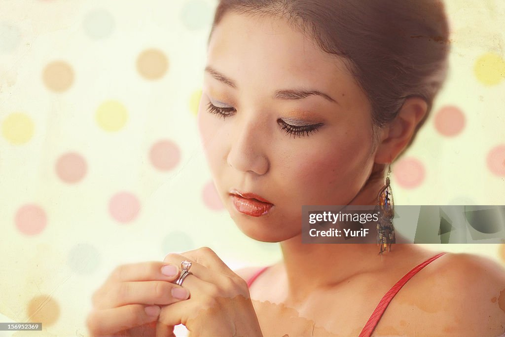 Woman looks at her ring.