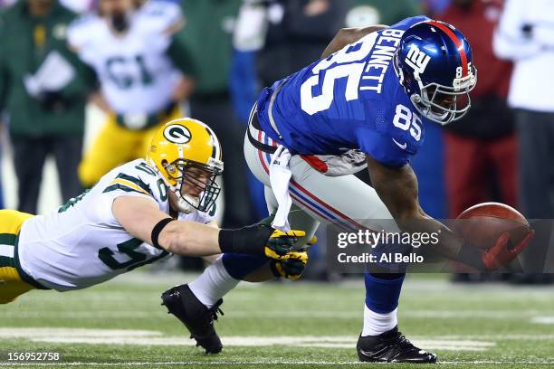 Tight end Martellus Bennett of the New York Giants makes a catch against inside linebacker A.J. Hawk of the Green Bay Packers at MetLife Stadium on...