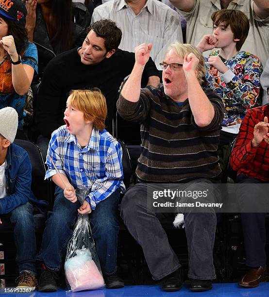 Philip Seymour Hoffman and son Cooper Alexander Hoffman attend the Detroit Pistons vs New York Knicks game at Madison Square Garden on November 25,...
