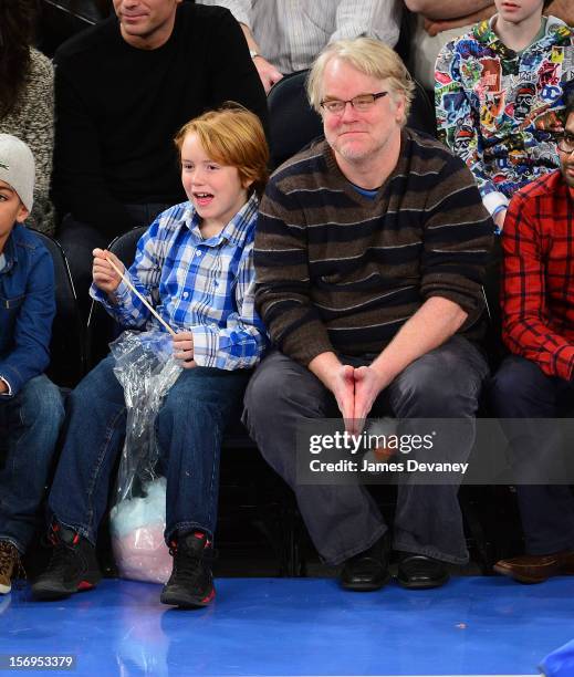 Philip Seymour Hoffman and son Cooper Alexander Hoffman attend the Detroit Pistons vs New York Knicks game at Madison Square Garden on November 25,...