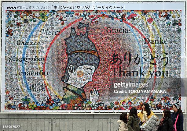 Japan-disaster-FSkate-Prix-JPN,FOCUS by Shigemi Sato In a picture taken on November 25 spectators chat under a mosaic art piece expressing grattitude...