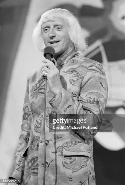 English DJ and television presenter Jimmy Savile on 'Top Of The Pops', London, UK, 24th April 1972.