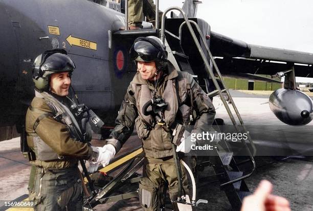 Picture dated 1993 showing Israeli Labor party leader then Israeli army chief of staff Ehud Barak shakes hands with a British pilot after flying a...