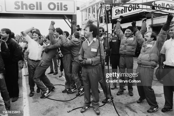 Members of the McLaren-TAG pit crew celebrate as French Grand Prix driver Alain Prost secures his first Drivers' Championship at the European Grand...