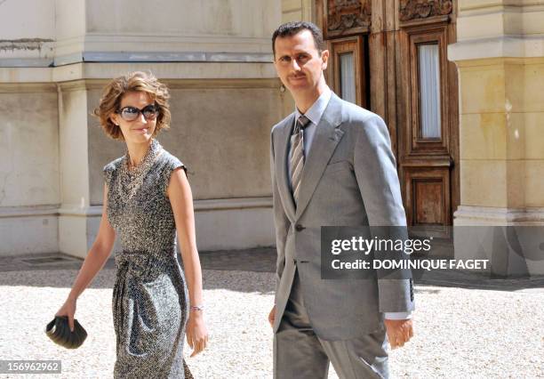 Syrian President Bashar al-Assad and his wife Asma arrive at the Elysee palace on July 14, 2008 in Paris, to attend the traditional garden party as...