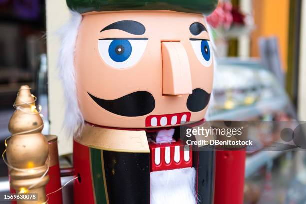 detail of the head of the figure of a christmas nutcracker soldier dressed in full military dress. christmas, decoration, new year and celebration concept. - nutcracker stock pictures, royalty-free photos & images