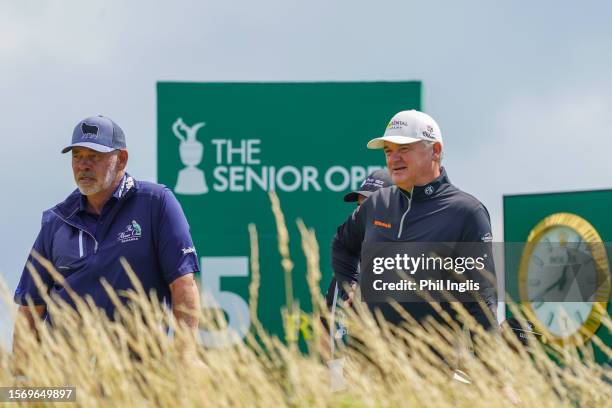 Paul Lawrie of Scotland waits on the tee with Darren Clarke of Northern Ireland in prior to The Senior Open Presented by Rolex at Royal Porthcawl...