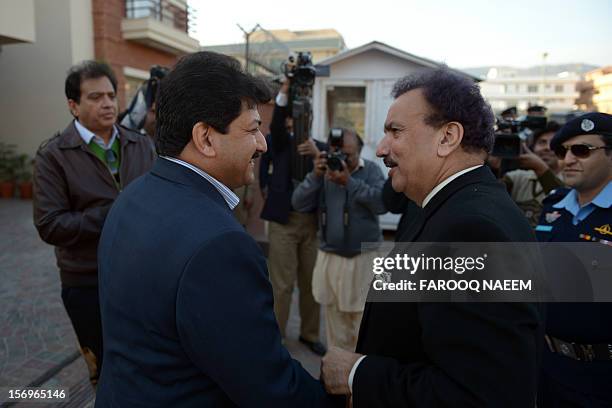 Pakistani Interior Minister Rehman Malik speaks with journalist and television anchor, Hamid Mir upon arrival at his home in Islamabad on November...