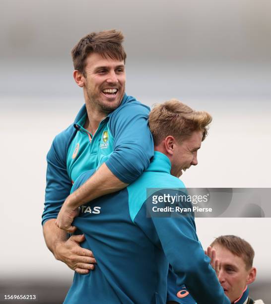 Mitch Marsh and Cameron Green of Australia react while warming up during the Australia Nets Session at The Kia Oval on July 25, 2023 in London,...