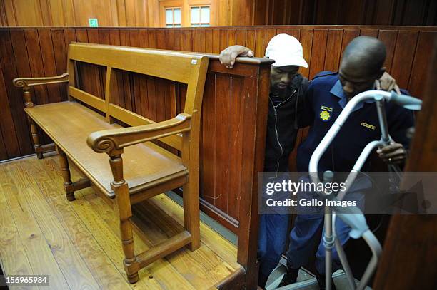 Accused murderer Xolile Mngeni enters Cape Town High Court on November 26, 2012 in Cape Town, South Africa. Mngeni was found guilty of robbery with...