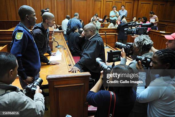 Photographers surround Xolile Mngeni in the Cape Town High Court on November 26, 2012 in Cape Town, South Africa. Mngeni was found guilty of robbery...