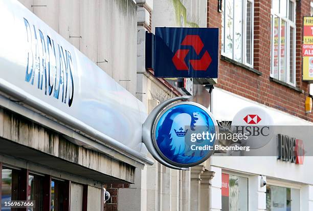 Signs sit outside branches of a Barclays Bank Plc bank, a NatWest bank, part of the Royal Bank of Scotland Group Plc , and a HSBC Holdings Plc bank...