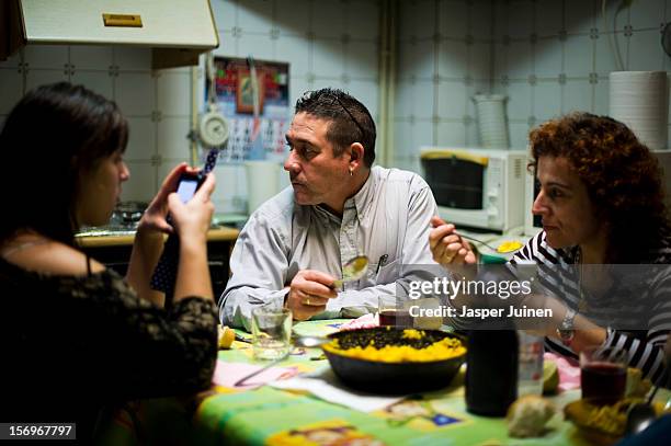 Forty-eight year old former door factory worker Angel Perez Fernandez eats Paella together with his forty-year old wife, Maria Regine Bueno Villar ,...