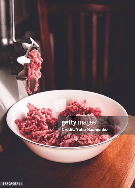 cooking minced meat in a meat grinder. - meat grinder stock pictures, royalty-free photos & images