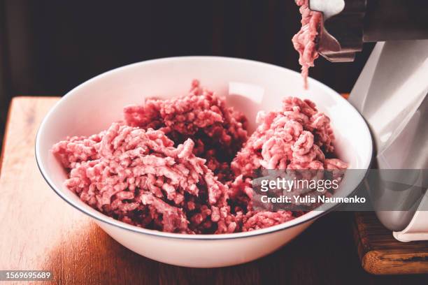 cooking minced meat in a meat grinder. - raw meat stock pictures, royalty-free photos & images