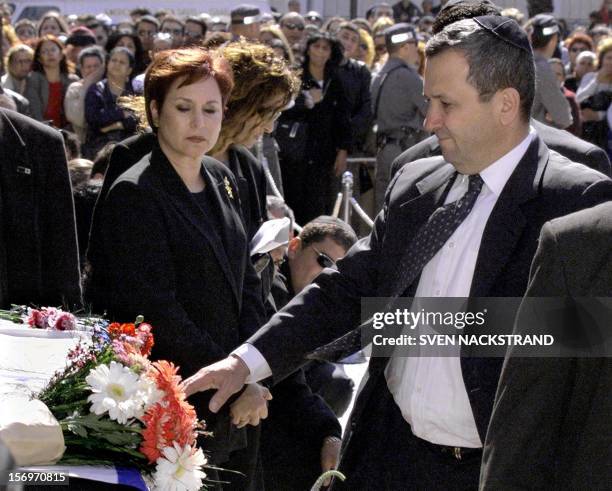 Israeli Prime Minister Ehud Barak, accompanied by his wife Nava, touches coffin of Israeli singer Ofra Haza during a pre-funeral ceremony in Tel Aviv...