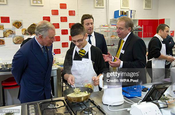 Prince Charles, Prince of Wales speaks a pupil during a visit to Carshalton Boys Sports College with Jamie Oliver to see how the school has...