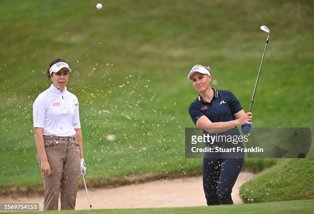 Ryan O'Toole of USA plays a shot whilst being watched by her partner Georgia Hall of England during the Amundi Evian Championship at Evian Resort...