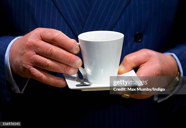 Prince Charles, Prince of Wales holds a cup and saucer as he, accompanied by Jamie Oliver, visits Carshalton Boys Sports College to see how the...