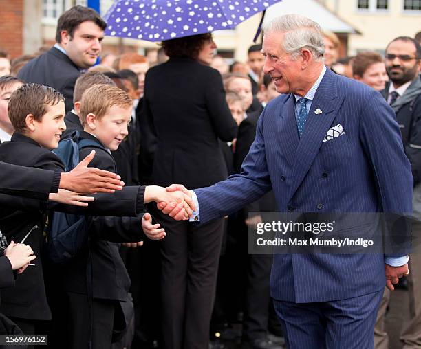 Prince Charles, Prince of Wales shakes hands with pupils as he, accompanied by Jamie Oliver, visits Carshalton Boys Sports College to see how the...