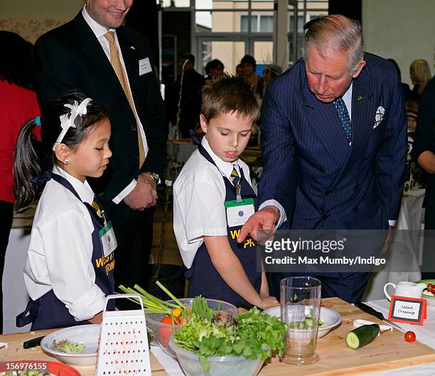 Prince Charles, Prince of Wales talks with school children doing a cookery demonstration as he, accompanied by Jamie Oliver, visits Carshalton Boys...