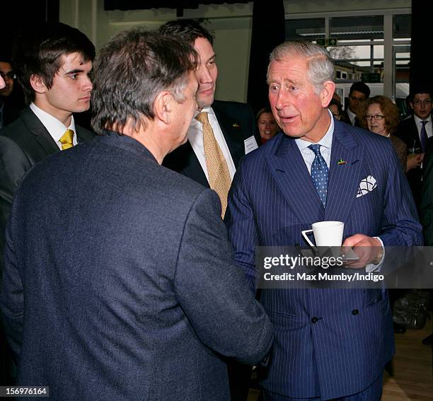 Prince Charles, Prince of Wales meets chef Raymond Blanc as he, accompanied by Jamie Oliver, visits Carshalton Boys Sports College to see how the...