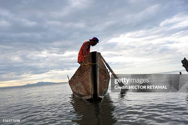 By Blanca Morel Thirty-five-year-old fisherman Adonis Mena, smiles as he gets ready to go out fishing on Xolotlan Lake, also known as Lake Managua,...