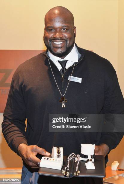 Shaquille O'Neal celebrates launch of his new men's jewelry line with Zales, by helping customers from behind the counter, on November 26, 2012 in...