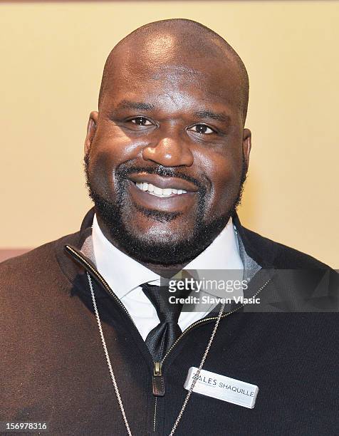 Shaquille O'Neal celebrates launch of his new men's jewelry line with Zales, by helping customers from behind the counter, on November 26, 2012 in...