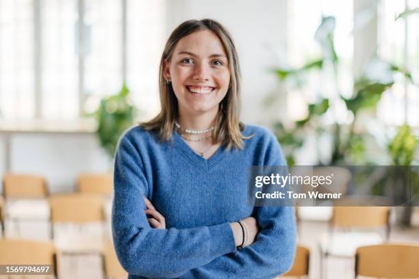 portrait of seminar participant wearing blue jumper - young women stock pictures, royalty-free photos & images