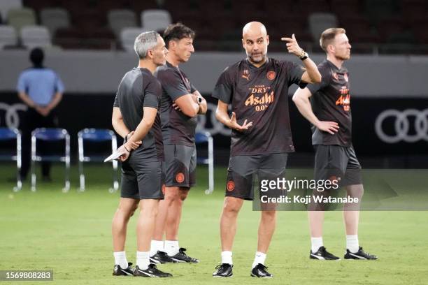 Pep Guardiola of Manchester City looks on during the Manchester City press conference & training session at National Stadium on July 25, 2023 in...