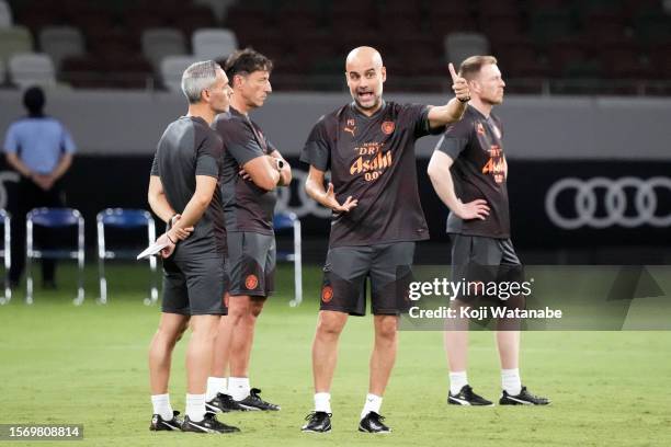 Pep Guardiola of Manchester City looks on during the Manchester City press conference & training session at National Stadium on July 25, 2023 in...