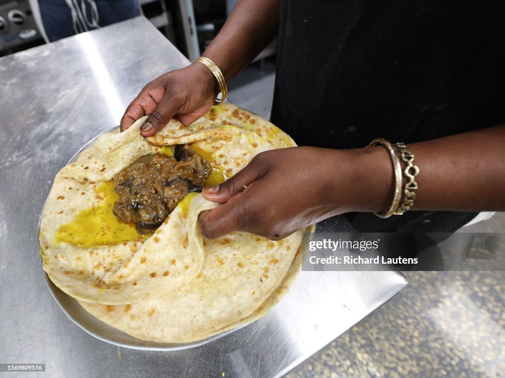 Vicky Roti TORONTO, ON - August 1 Owner Vicki wraps up a roti. Island Foods at ...