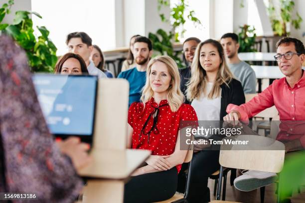 view of audience from podium during seminar presentation - business presentation stock pictures, royalty-free photos & images