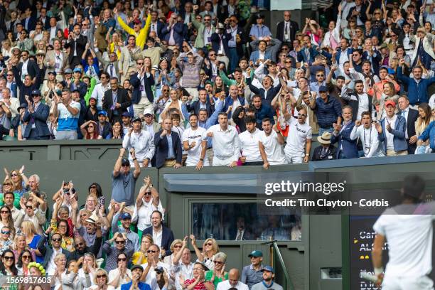 Coach Juan Carlos Ferrero and the team of Carlos Alcaraz of Spain react in the team box during his five-set victory against Novak Djokovic of Serbia...