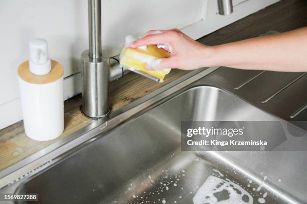 cleaning the faucet - liquide vaisselle photos et images de collection